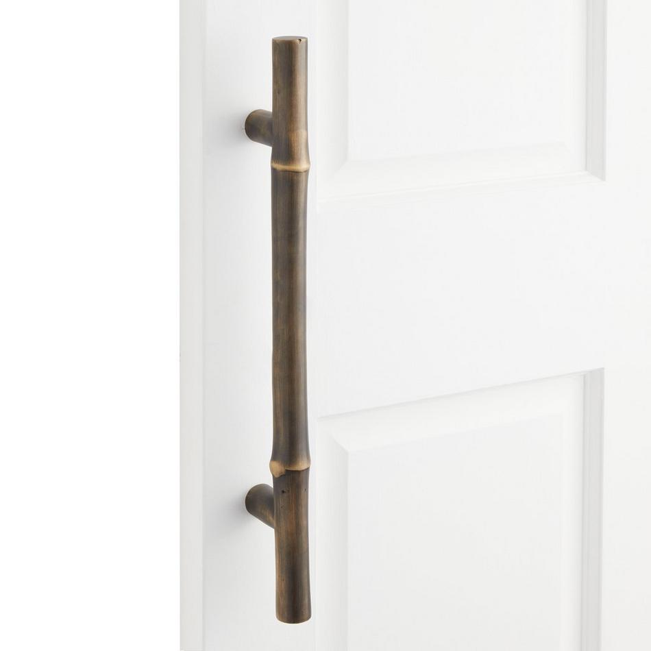 An Ornate Pull Made Of Brass For A Sliding Door