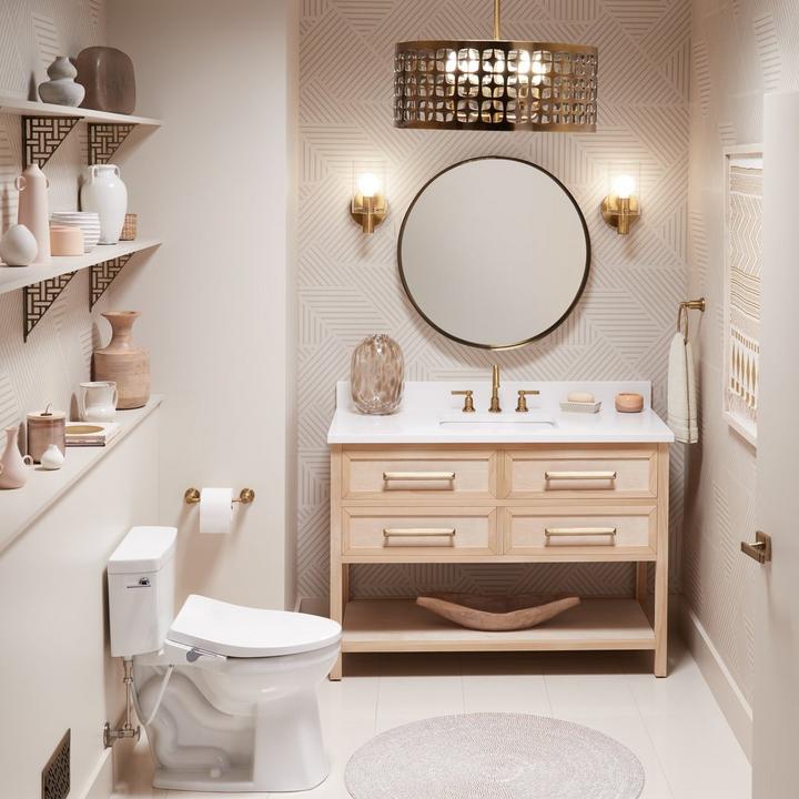 Art deco style bathroom with the Duxford 5-Light Pendant, Greyfield Widespread Faucet, Towel Holder, Adreo Sconce in Aged Brass