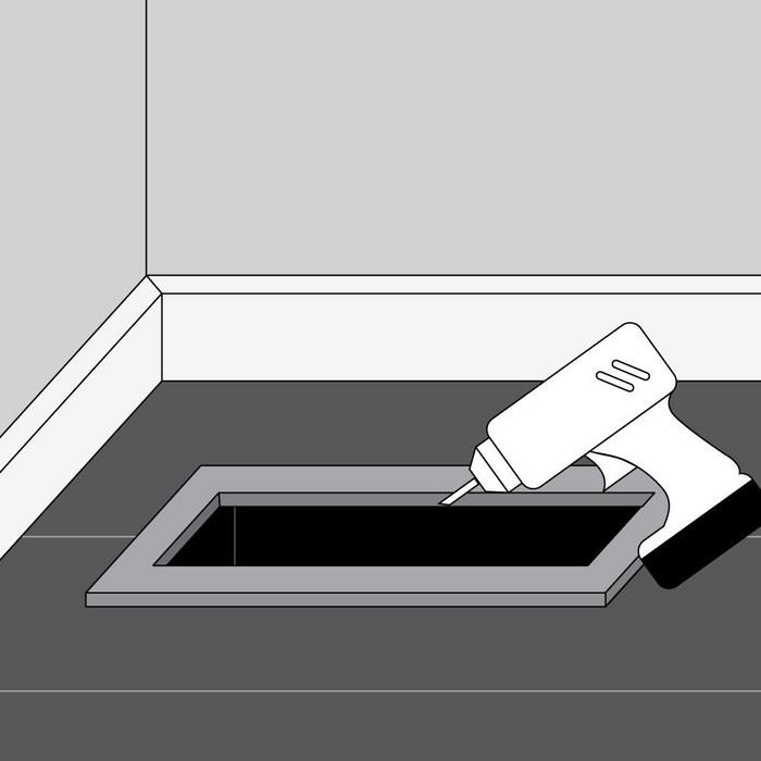 Install flush-mount floor register step 2 - drill a pilot hole into the recessed area of the frame at an angle into the floor