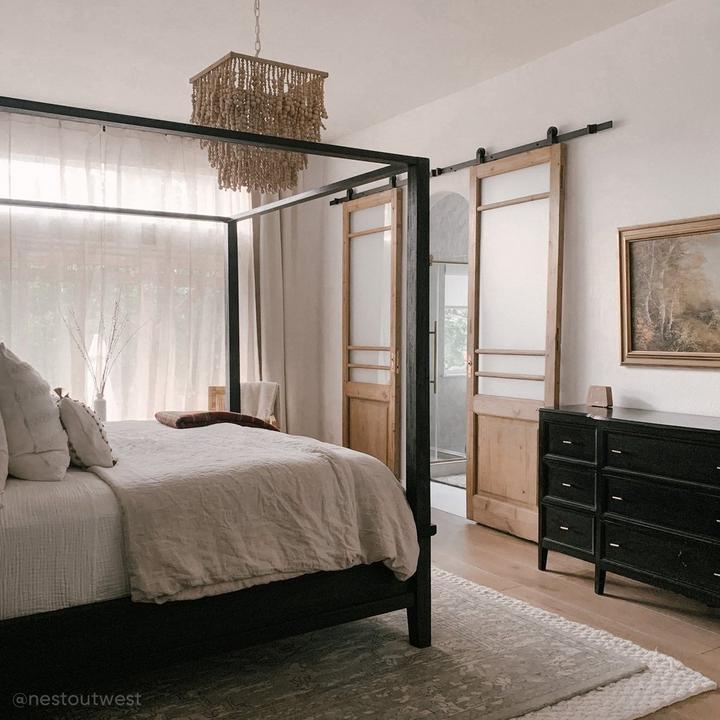 Bohemian style bedroom with the 78" Bowden Top-Mount Barn Door Hardware Kit in Black