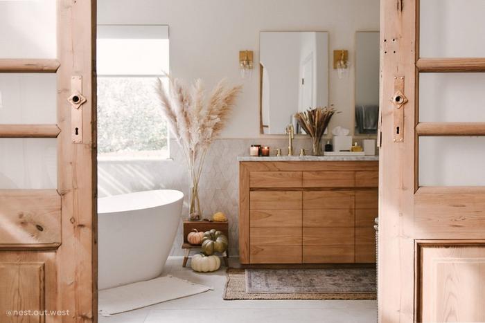 Rotunda Widespread Faucet in Polished Brass, 56" Winifred Resin Freestanding Tub, 70" Bastian Teak Vanity in Natural Teak