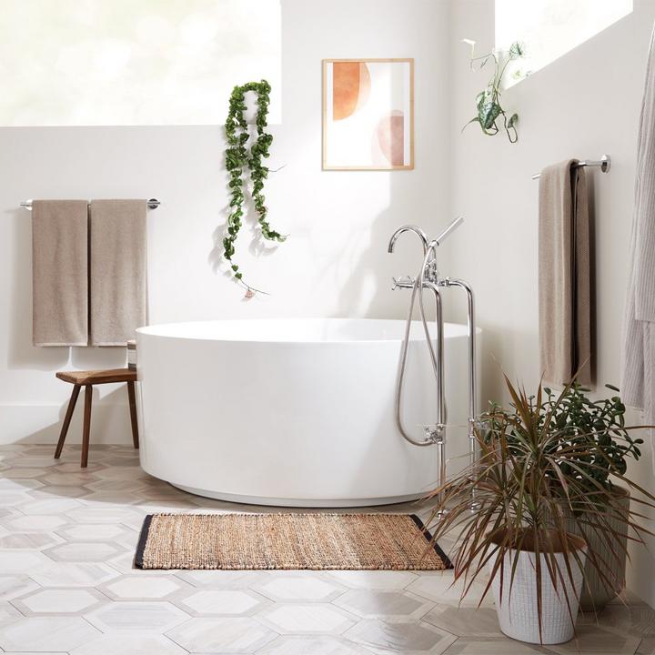 bathroom with modern freestanding tub and chrome tub faucet