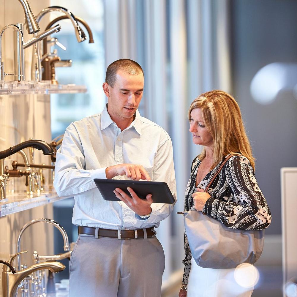 sales associate and customer looking at tablet