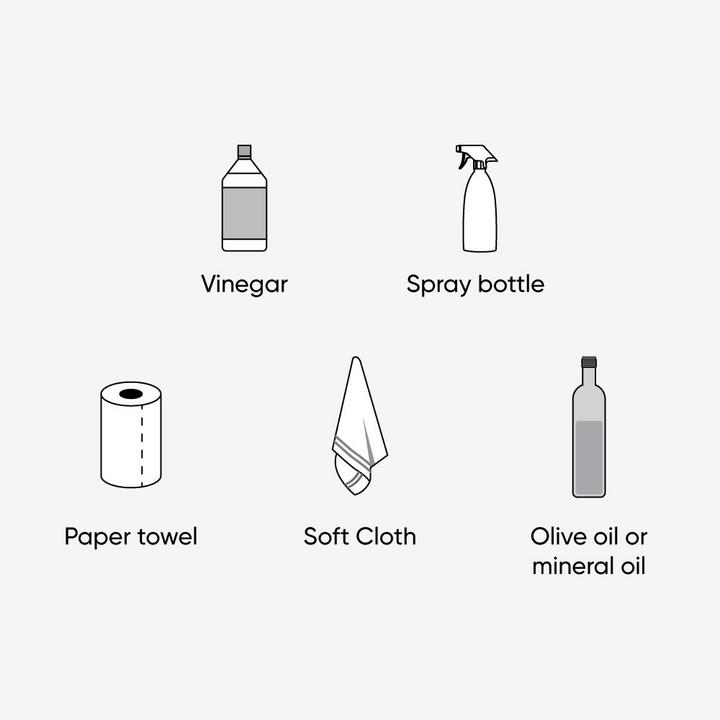 Illustration of tools & materials to clean stainless steel using method 2 - vinegar, spray bottle, paper towel, soft cloth