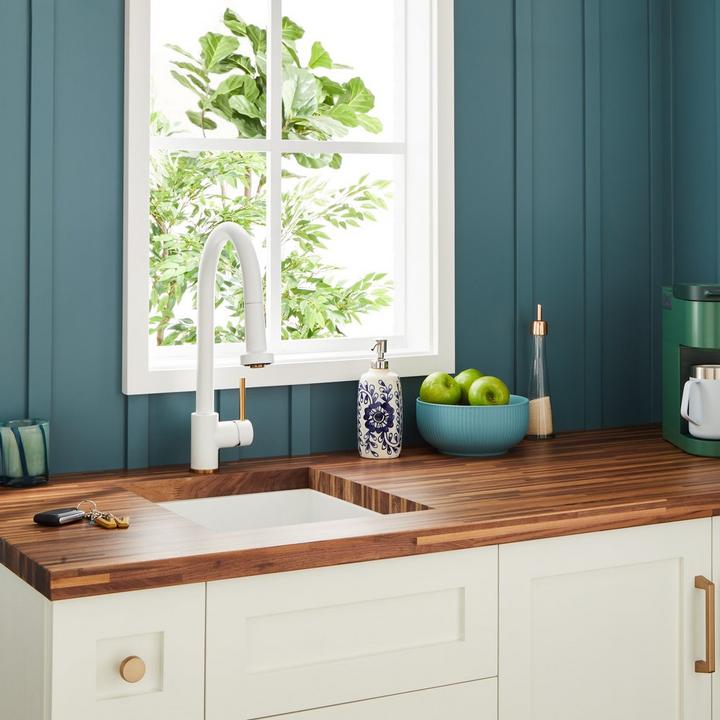 Ridgeway Pull-Down Two-Tone Kitchen Faucet in Brushed Gold and Matte White on a coffee bar