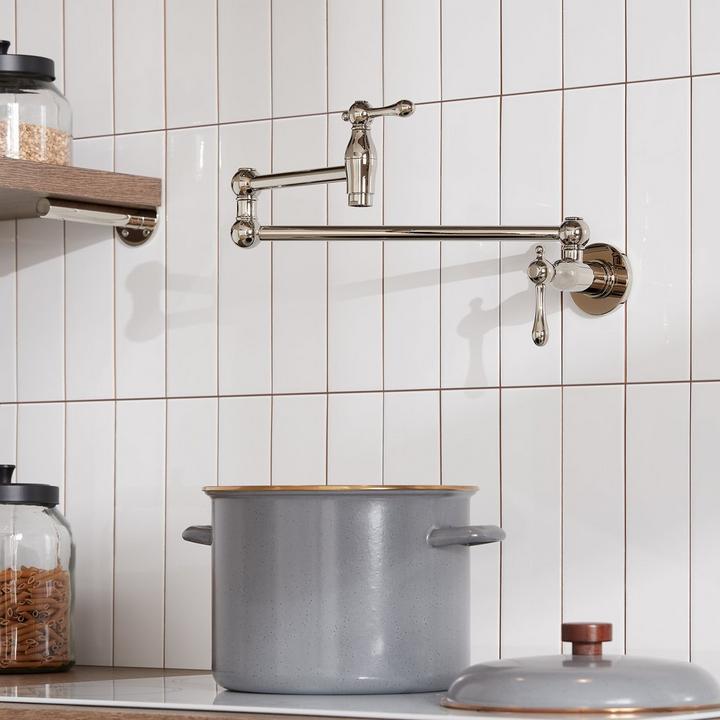 Traditional Retractable Wall-Mount Pot Filler Faucet in Polished Nickel over a kitchen stove