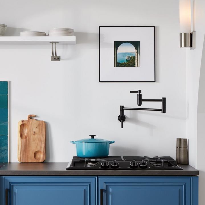 Contemporary Retractable Wall-Mount Pot Filler Faucet in Matte Black in a modern kitchen