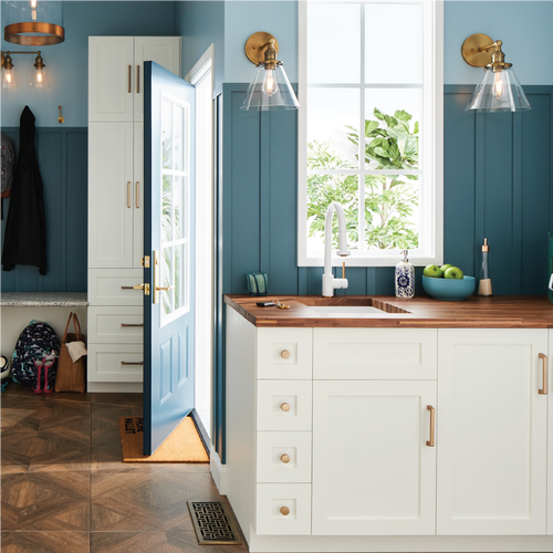 Well organized mudroom with the Ridgeway Faucet in Matte White