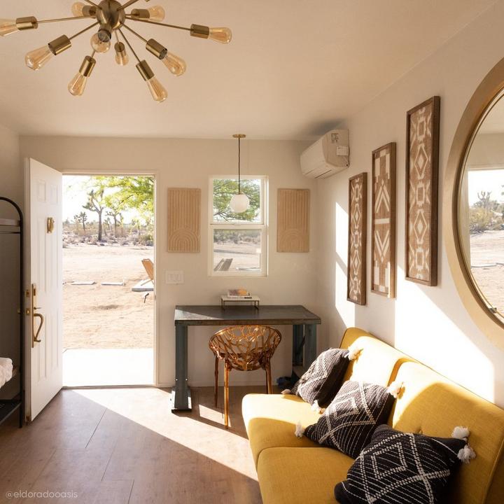 Living room of El Dorado Oasis with the Traeger Solid Brass Entrance Door Set with Knob in Satin Brass & Owl Brass Door Knocker