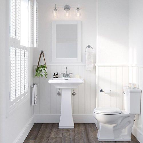 bright bathroom with pedestal sink and porcelain toilet