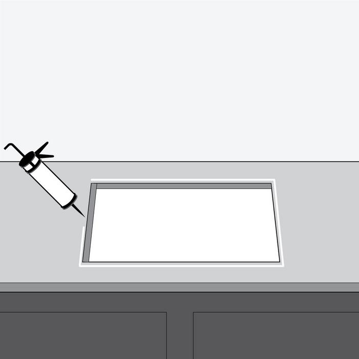 Step 2 - remove sink and run a bead of silicone sealant around the sink cutout to seal the rim against moisture and leaks