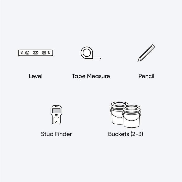 Tools and materials for floating vanity installation - level, tape measure, pencil, stud finder, buckets