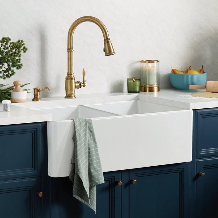Unique U-shape fits around plumbing. With two trays, this sink
