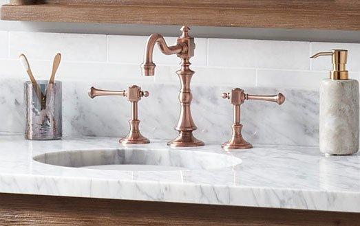 Widespread faucet on a vanity top.