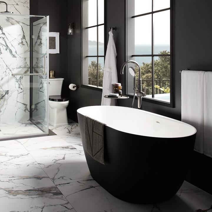 Bathroom with the 59" Catino Solid Surface Freestanding Tub with Matte Black Exterior and other matte black bathroom fixtures
