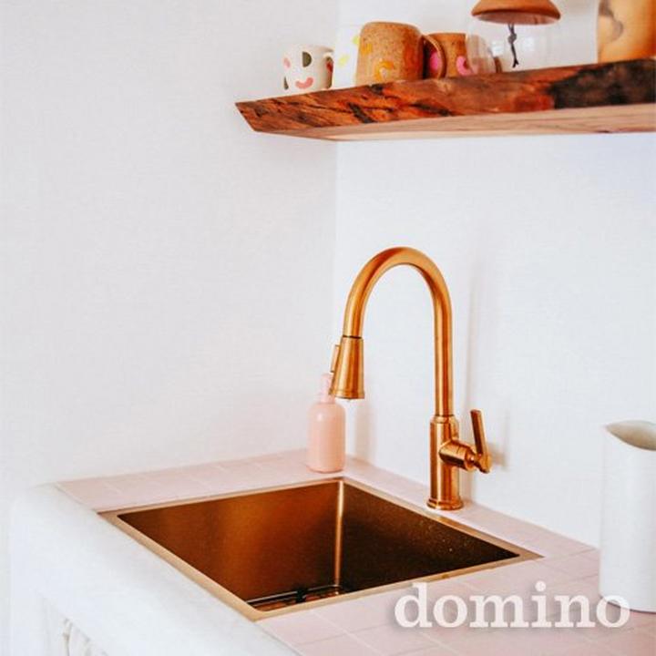 kitchen sink with brass faucet