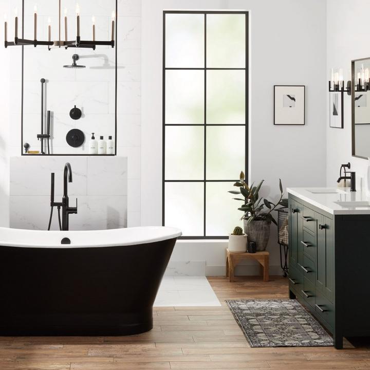 Minimalist bathroom with 67" Kateryn Bateau Cast Iron Skirted Tub in Black, Lentz Freestanding Tub Faucet in Matte Black
