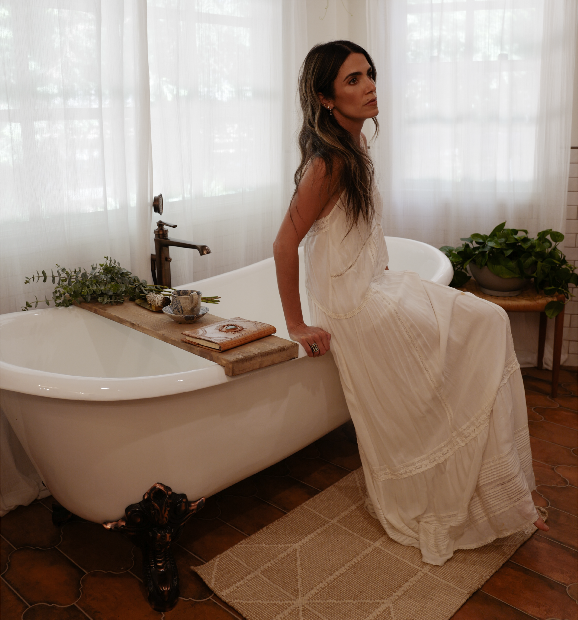 Nikki Reed sitting on the 72 inch Lena Cast Iron Clawfoot Tub