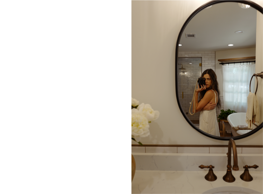 Nikki Reed taking a photo in the Colborne Oval Decorative Vanity Mirror - Matte Black