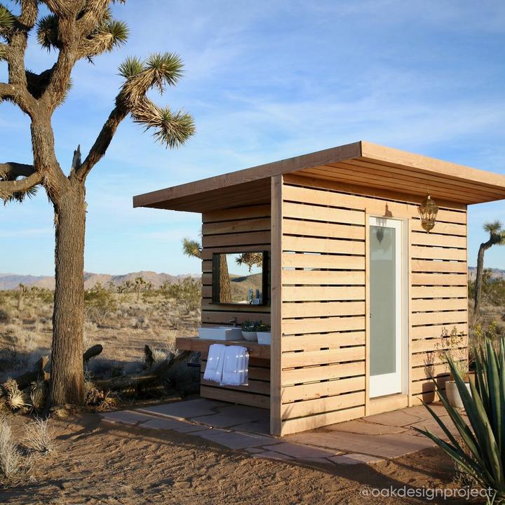 Front of an outdoor bathroom designed by Oak Design Project