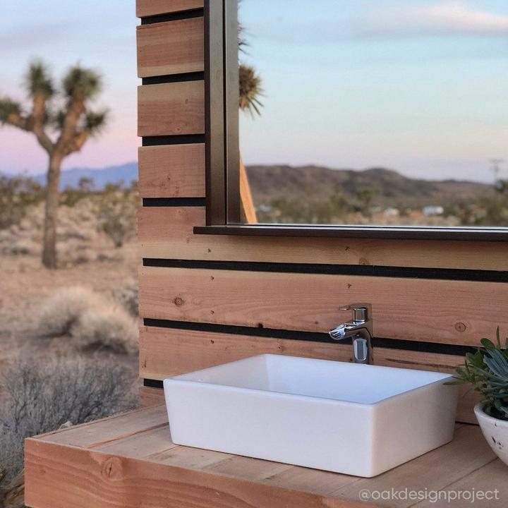 Closeup of vessel sink and faucet in an outdoor bathroom designed by Rachelle Lazzaro and Kevin Bennert of Oak Design Project