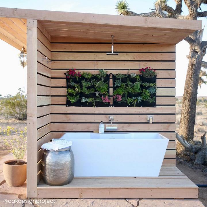 Outdoor bathroom by Oak Design Project with Ryle Rainfall Shower Set in Chrome, 67" Hibiscus Rectangular Freestanding Tub