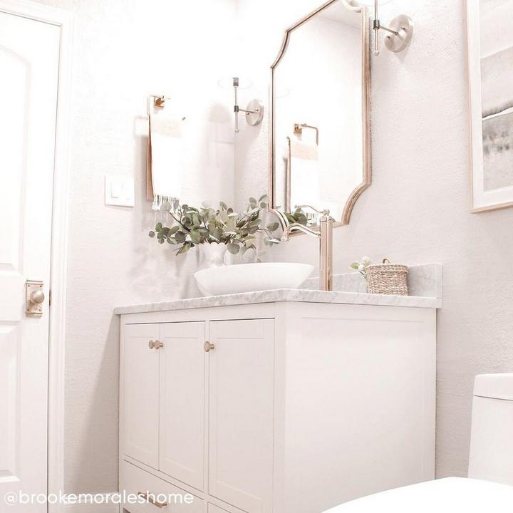 powder room design by Brooke Morales with the Ulric Decorative Vanity Mirror in Gold Leaf, Beatty Wall Sconce in Antique Brass
