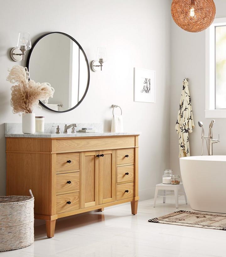 bathroom with teak vanity and freestanding tub
