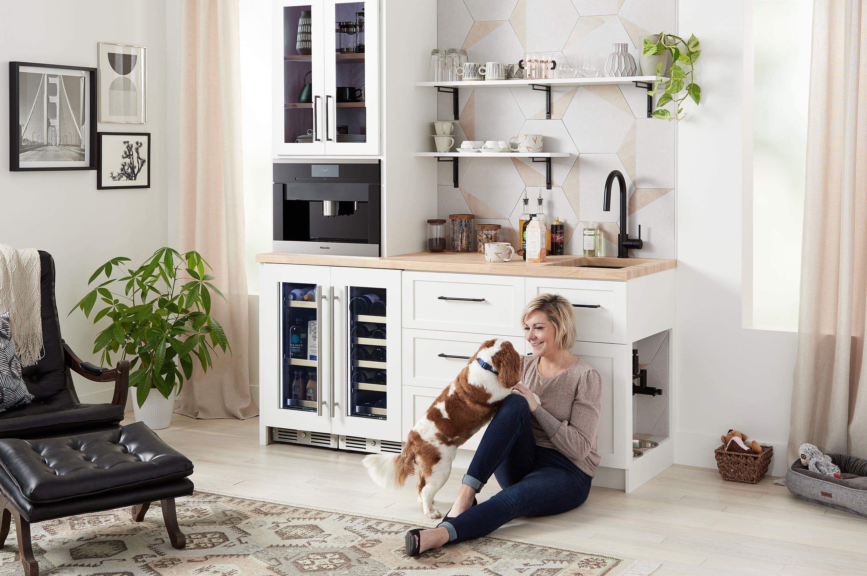 woman in modern kitchen with a dog