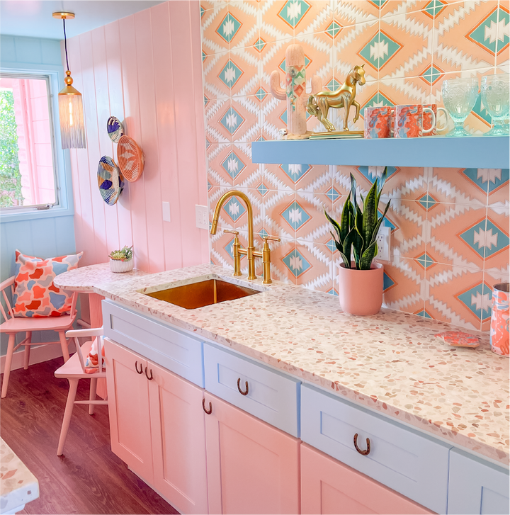 colorful kitchen with gold bridge faucet