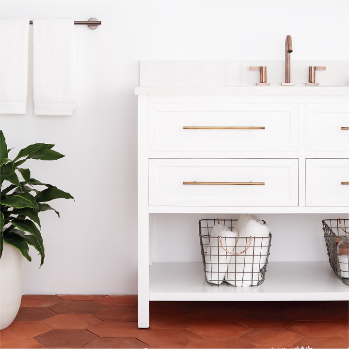 white bathroom vanity with gold hardware and faucet