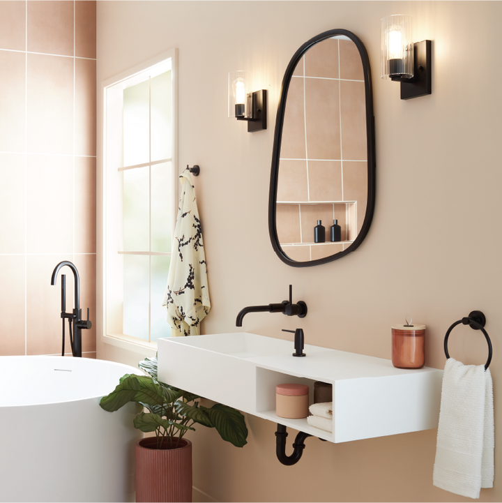 pink bathroom with black faucets and hardware