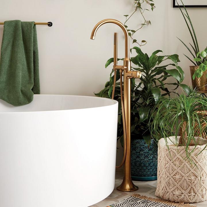 Lentz Freestanding Tub Faucet in Brushed Gold with indoor plants for home decor tips