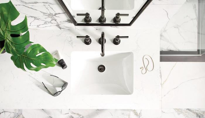 Greyfield Freestanding Faucet in Gunmetal on a Feathered White Quartz Vanity Top for quartz countertop care and maintenance