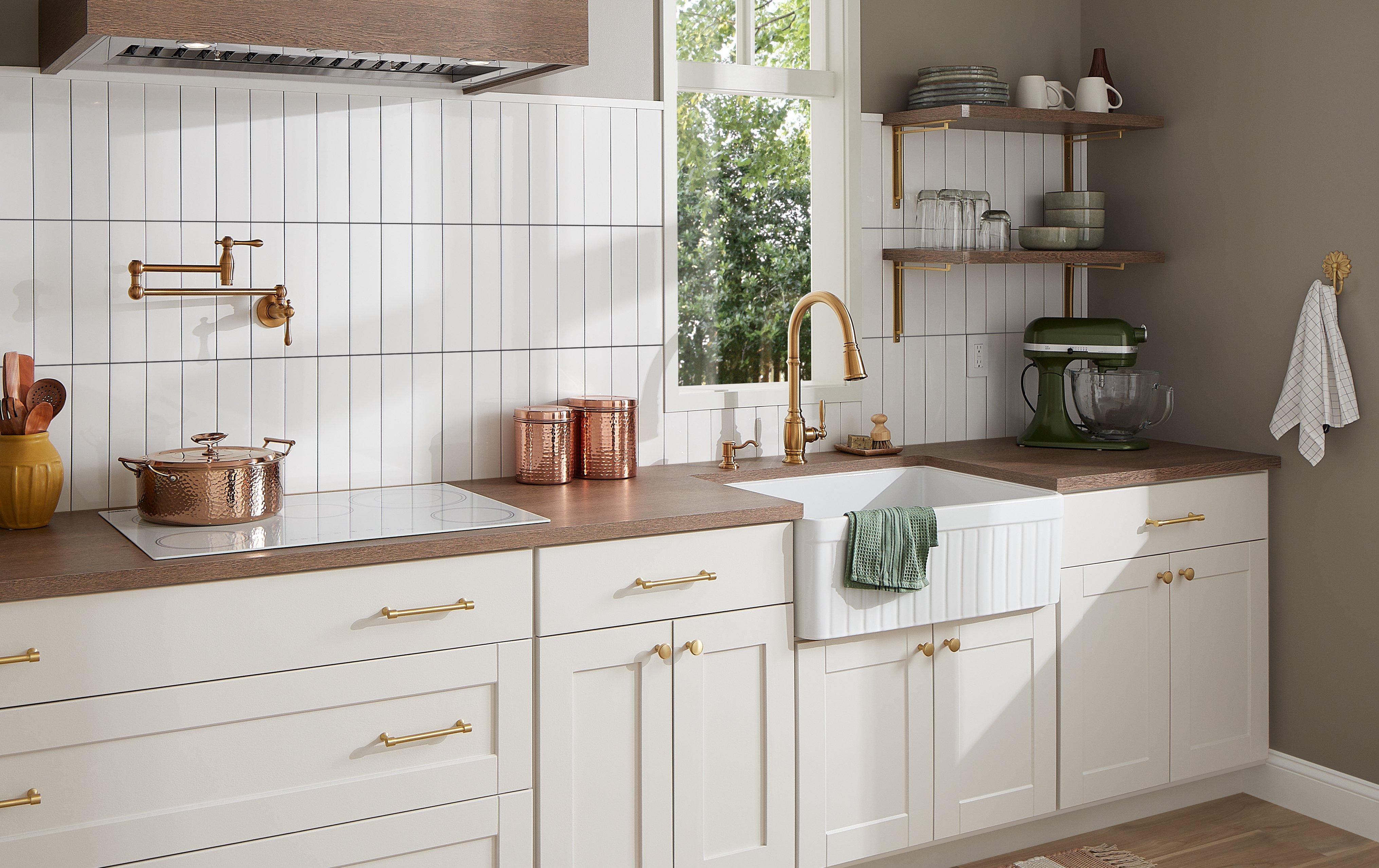 white kitchen with Finnian Kitchen Faucet in Brushed Gold, Strasbourg Cabinet Pull & Knob, Harridge Bracket in Satin Brass