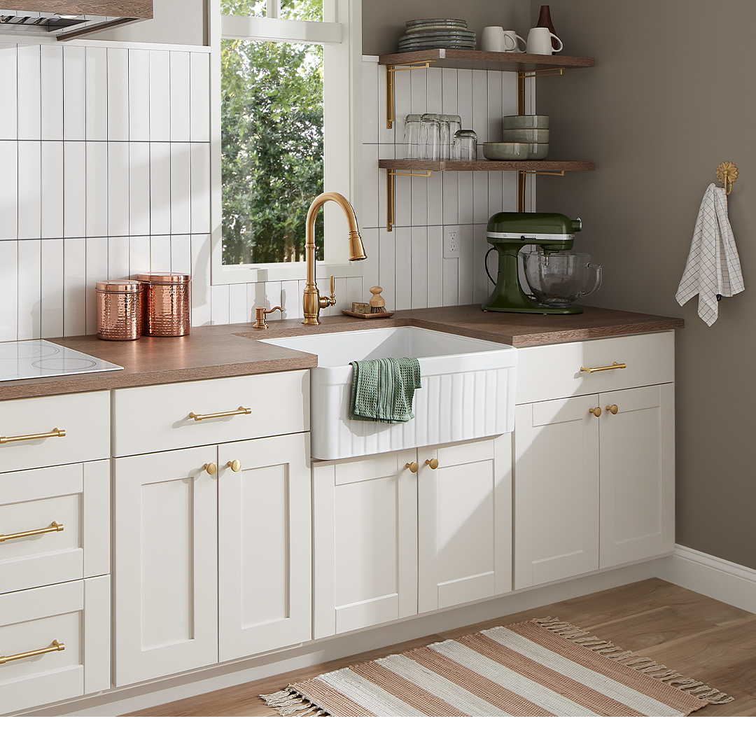 white kitchen with Finnian Kitchen Faucet in Brushed Gold, Strasbourg Cabinet Pull & Knob, Harridge Bracket in Satin Brass